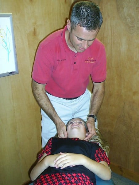 Chiropractor Oneida NY Peter Lombardi and adjusting neck
